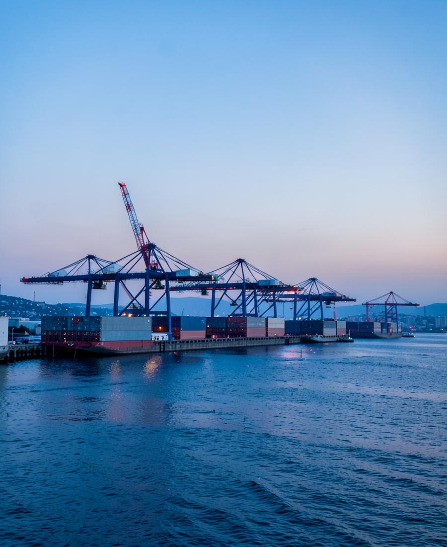 Container port cranes at dawn